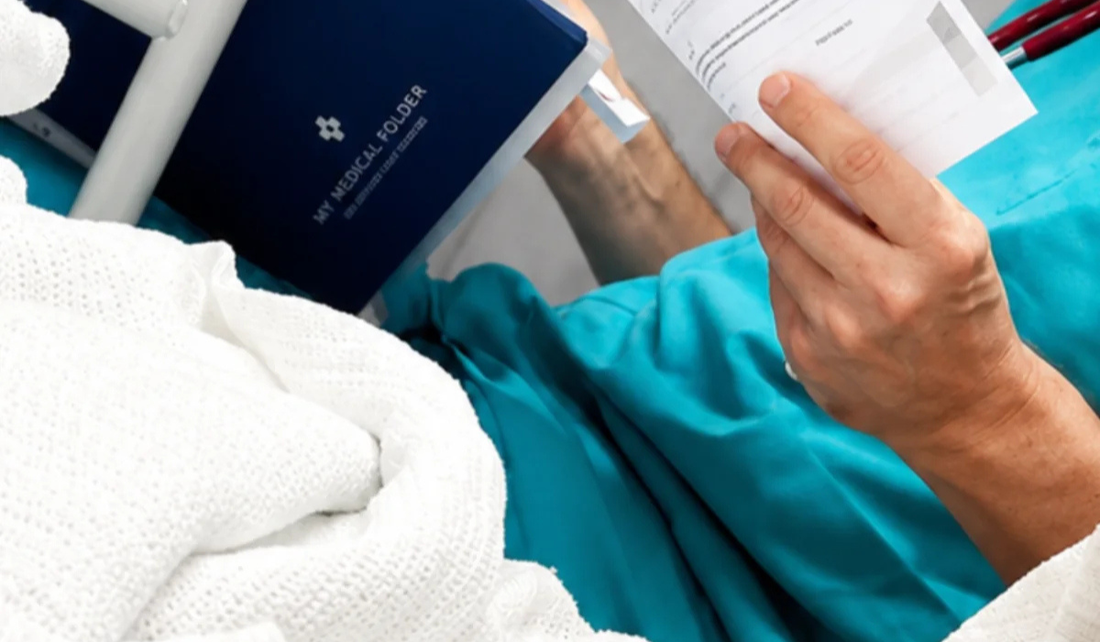 Patient using a My Medical Folder to keep medical records and healthcare documents organised during a hospital stay.